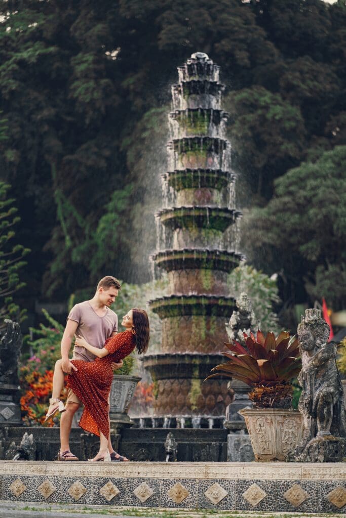 Couple posing for photo in front of bali fountain