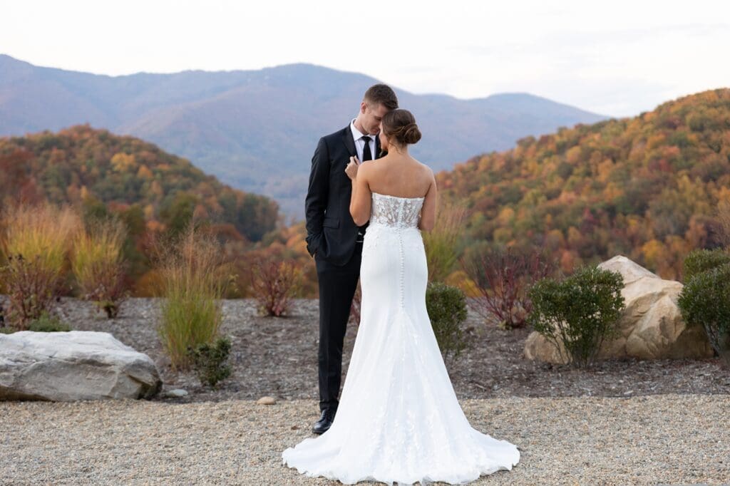 Couple embracing after getting married with the mountains and fall colors behind them