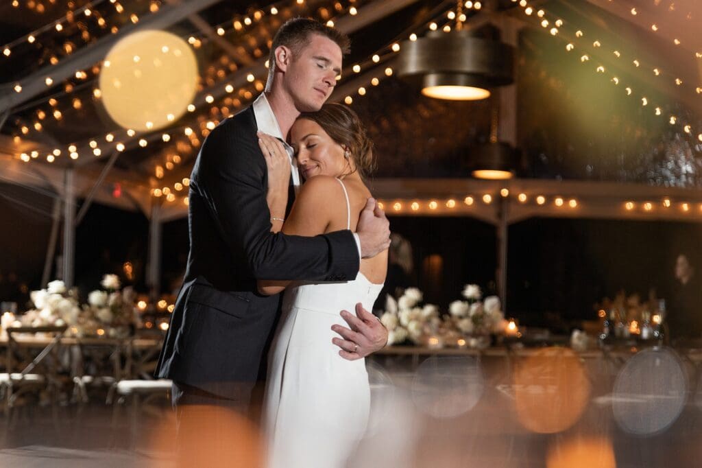 Couple holding each other tight during their final private dance.