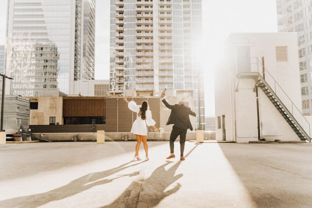 Couple dancing during their parking lot engagement session in charlotte