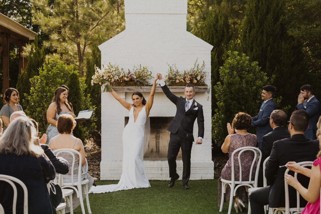 Couple just after saying I do and cheering in excitement.