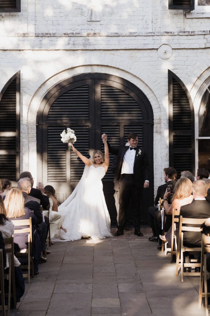 A bride and groom just got married and is celebrating before their love ones.