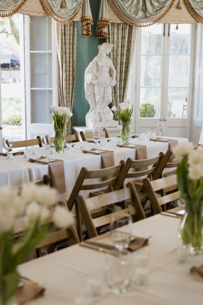 Inside the The William Aiken House with a wedding reception ready for dinner with floral and decor.