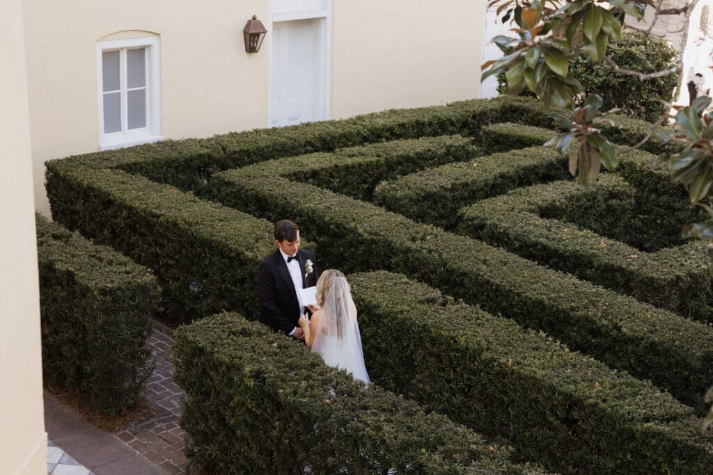 A couple reading private vows in the garden at The William Aiken House