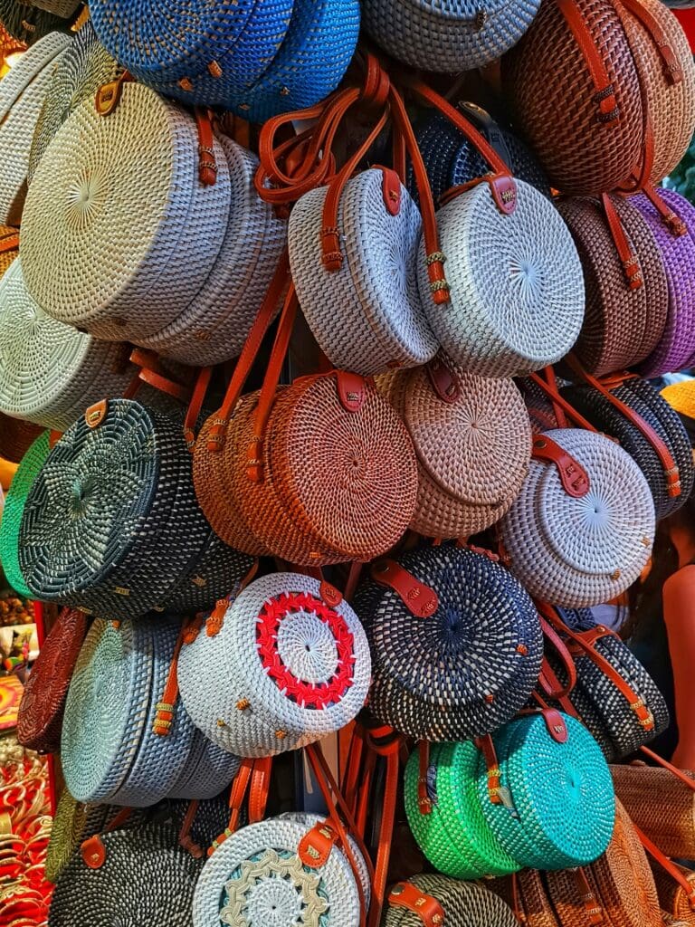 Handmade colorful bins hanging on display for sale