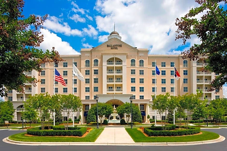 The Ballantyne Hotel exterior features a grand cream colored facade, elegant columns and manicured grounds with a Southern Charm of Charlotte North Carolina wedding venue.